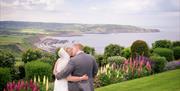 An image of bride and groom on Raven Hall Country House Hotel grounds