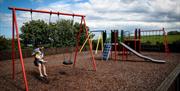 An image of a father and son playing in the park