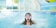 An image of girl in swimmer pool under water feature at Primrose Valley Holiday Park