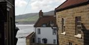 An image of Old Coastguards Station Visitor Centre in the distance.