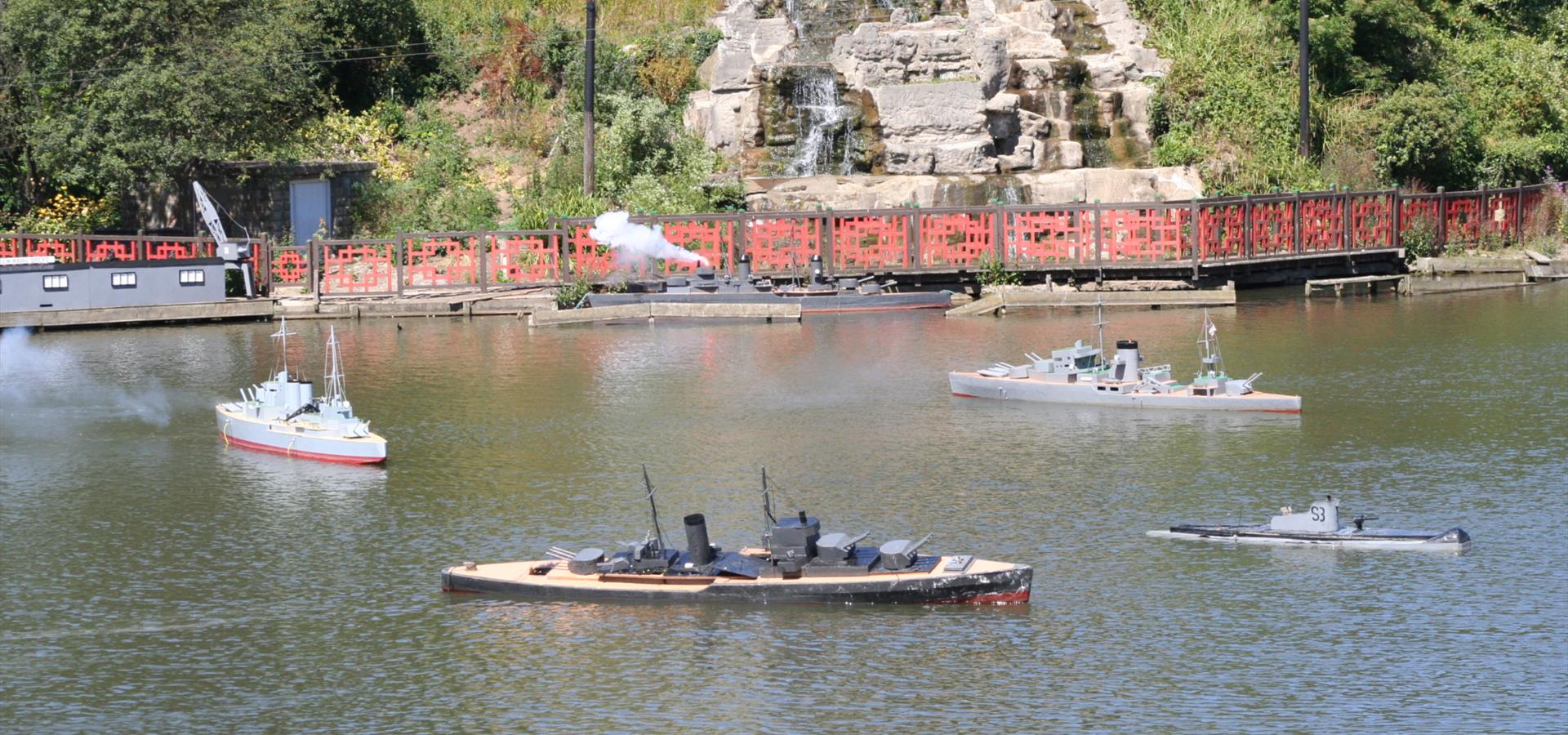 Miniature military boats on a pond