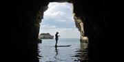 An image of a paddleboarder in a cave