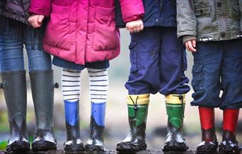 Four kids with muddy boots