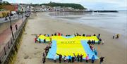 An image of a Tour de Yorkshire giant T-shirt on Scarborough's south bay beach