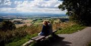 An image of two people sat looking at the view from Sutton Bank National Park Centre