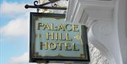 An image of the Palace Hill Hotel sign