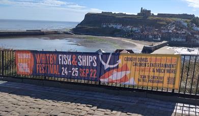 An image of the Fish & Ships banner from 2022 overlooking Whitby harbour