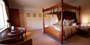 An image of a four poster bedroom at The Blacksmiths Arms.