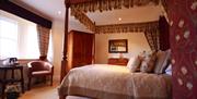 An image of a four poster bedroom at The Blacksmiths Arms.