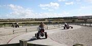 An image of children on pedal go karts at Playdale Farm Park
