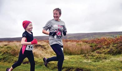 An image of two runners taking part in a moors run.