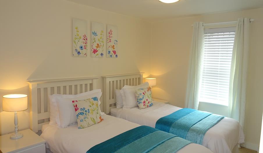 An image of a twin bedroom at Royal Sands