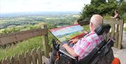 An image of a man looking at view from Sutton Bank National Park Centre