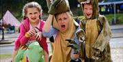 An image of children dressed up as dinosaurs at The Yorkshire Fossil Festival