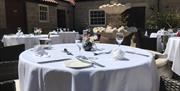 An image of outside Courtyard Restaurant silver service table setting.