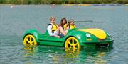 An image of people on a car pedalo