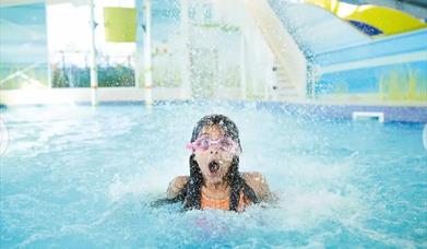 An image of girl in swimmer pool under water feature at Primrose Valley Holiday Park