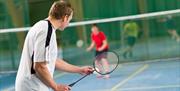 An image of two people playing badminton at Pindar Leisure Centre