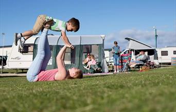An image of a family enjoying there time at Reighton Sands Holiday Park - Touring