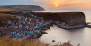 An image of a sunset over Staithes