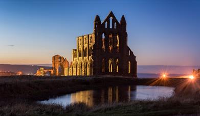 An image of Whitby Abbey at dusk
