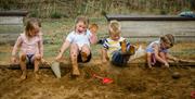 An image of children playing in the sand at Woldie's Lavender and Nature Farm