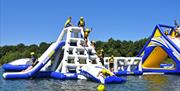 An image of people climbing on the inflatable aqua park