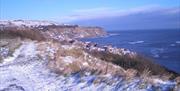 An image of Robin Hoods Bay in Snow