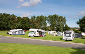 An image of caravans and tents set up at Scarborough Camping & Caravanning Club
